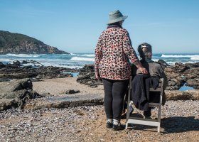man and woman looking at the ocean